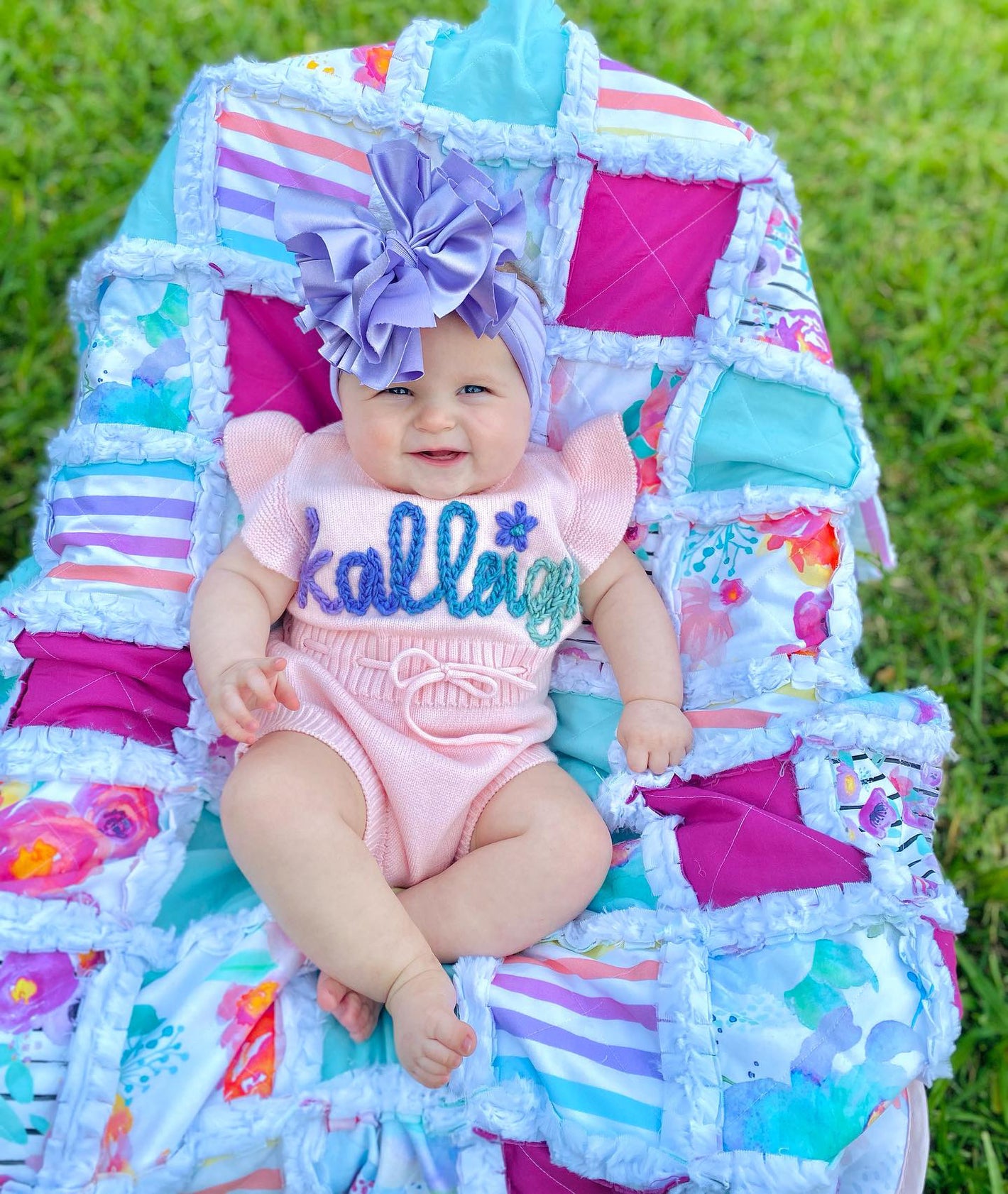 baby in personalized pink romper